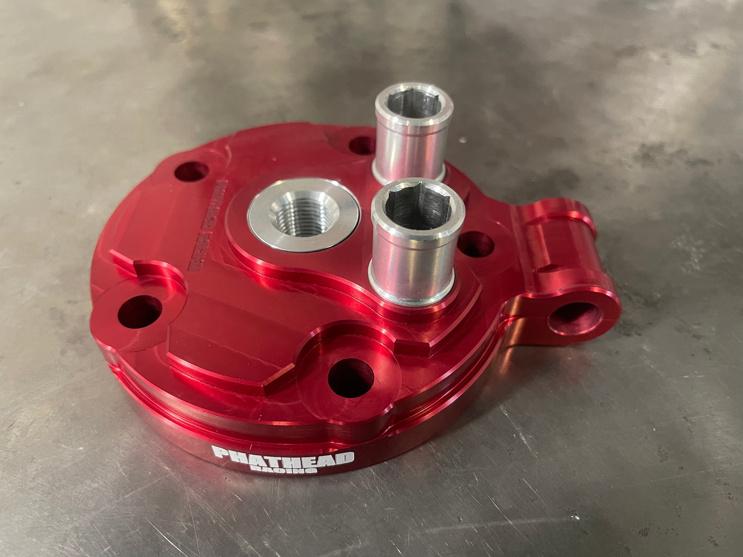 A red Phathead cylinder head kit for a Honda CR125 motorcycle
